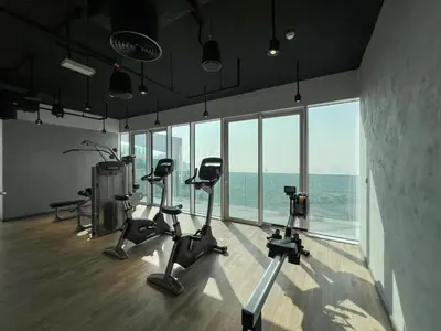 a gym with cardio equipment in a room with windows at 2BR 1 Residences Zabeel with Sleeps 5 - Luxury Stay in Dubai