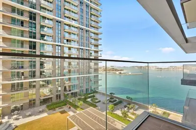 an apartment balcony with a view of the water at Your beachfront luxe escape experience - Suiteable in Dubai