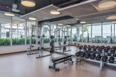 a gym with a bunch of equipment in a room at Your beachfront luxe escape experience - Suiteable in Dubai