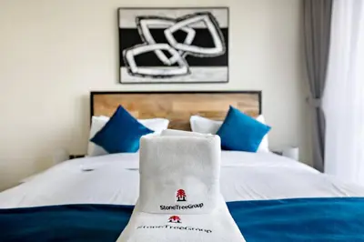a hotel room with a bed with blue pillows at Modern Style 1 BR near Marina Mall and Metro in Dubai