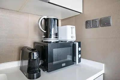 a coffee maker sitting on a counter in a room at Modern Style 1 BR near Marina Mall and Metro in Dubai