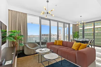 a living room with a couch and a table at Palm View Paradise 3 bed apartment w private beach in Dubai