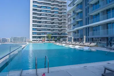 a large swimming pool in the middle of a building at Palm View Paradise 3 bed apartment w private beach in Dubai