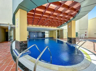 a large swimming pool in a large building at StoneTree - Unique 1BR Apartment in JLT in Dubai