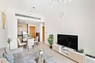 a living room with a large flat screen tv at StoneTree - Furnished 1BR with Canal View in Dubai