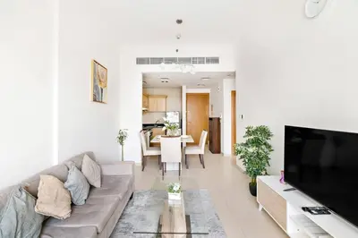 a living room with a couch and a table at StoneTree - Furnished 1BR with Canal View in Dubai