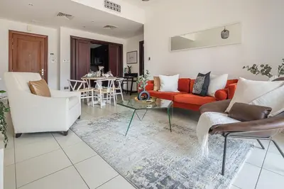 a living room with a red couch and chairs at Frank Porter - Reehan 1 in Dubai