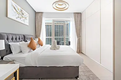 a bedroom with a large bed and a window at StoneTree - Fabulous 1BR Apartment in Dubai Marina in Dubai