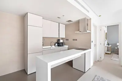 a kitchen with white cabinets and a white counter top at StoneTree - Fabulous 1BR Apartment in Dubai Marina in Dubai