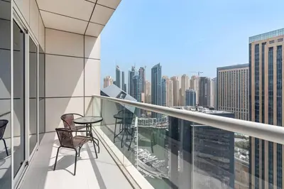a balcony with chairs and a view of the city at StoneTree - Fabulous 1BR Apartment in Dubai Marina in Dubai