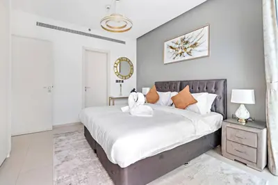 a bedroom with a large bed and a mirror at StoneTree - Fabulous 1BR Apartment in Dubai Marina in Dubai