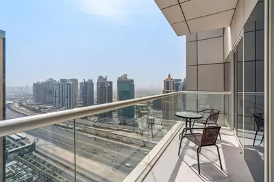a balcony with two chairs and a table on a building at StoneTree - Fabulous 1BR Apartment in Dubai Marina in Dubai