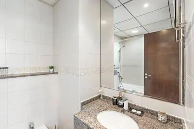 a bathroom with a sink and a shower at StoneTree - Modern 1 BR Apartment in Dubai Marina in Dubai