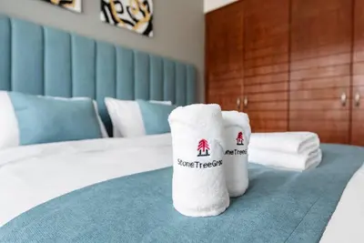 a pair of towels sitting on top of a bed at StoneTree - NEW Furnished 1BR in V3 Tower in Dubai