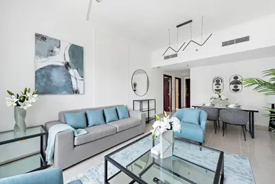 a living room with a couch and a table at StoneTree - NEW Furnished 1BR in V3 Tower in Dubai