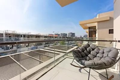 a balcony with a chair on top of a building at StoneTree - The Modern Family Friendly Villa in Dubai