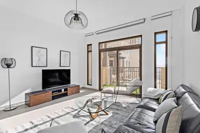 a living room with a couch and a television at StoneTree - Elegant 1 BR in Madinat Jumeirah Living Rahaal 2 in Dubai