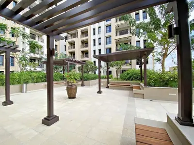 a patio in a building with a wooden pergola at StoneTree - Elegant 1 BR in Madinat Jumeirah Living Rahaal 2 in Dubai