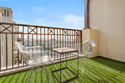 two chairs and a table on a balcony with a view at StoneTree - Elegant 1 BR in Madinat Jumeirah Living Rahaal 2 in Dubai