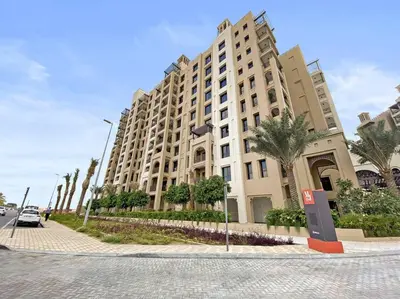 a large building on the side of a street at StoneTree - Elegant 1 BR in Madinat Jumeirah Living Rahaal 2 in Dubai
