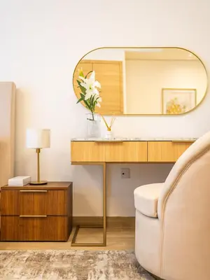 a living room with a mirror and a couch at Comfy and stylish Studio in Regina Towers - JVC in Dubai