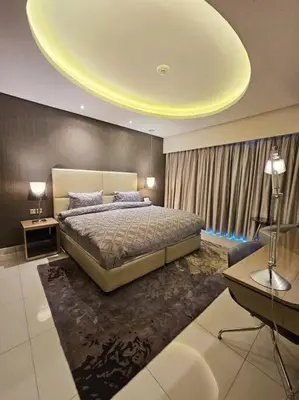 a bedroom with a large bed with a yellow ceiling at Luxury Paramount Hotel Apt D635 in Dubai