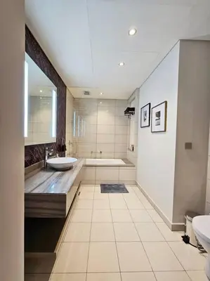 a large bathroom with a tub and a sink at Luxury Paramount Hotel Apt D635 in Dubai