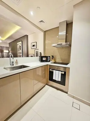 a large kitchen with a sink and a stove at Luxury Paramount Hotel Apt D635 in Dubai