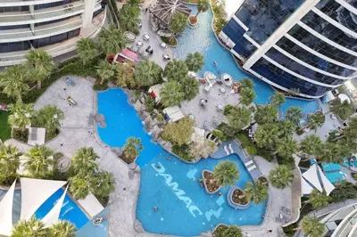 an aerial view of a pool at a resort at Luxury Paramount Hotel Apt D635 in Dubai