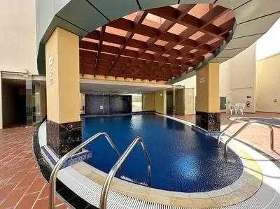 a large swimming pool in a large building at StoneTree - NEW Furnished Studio in JLT in Dubai
