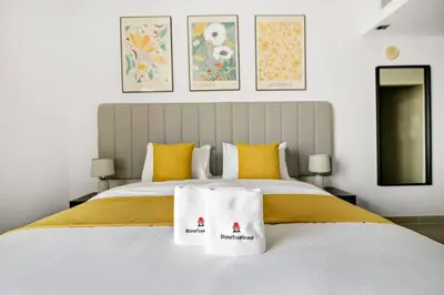 a bedroom with a bed with two towels on it at StoneTree - NEW Furnished Studio in JLT in Dubai