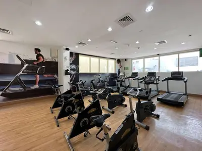 a gym with a bunch of exercise equipment in it at StoneTree - NEW Furnished Studio in JLT in Dubai