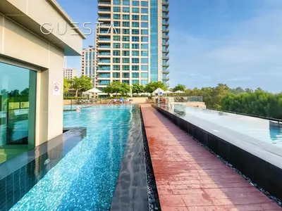 a swimming pool on the roof of a building at Fairways Tower by Emaar, The Views and Greens in Dubai
