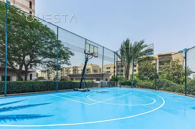 a basketball court with a basketball hoop on it at Fairways Tower by Emaar, The Views and Greens in Dubai