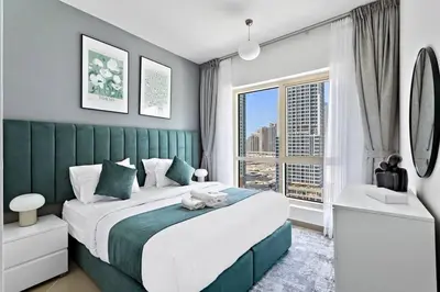 a bedroom with a large bed and a large window at StoneTree - NEW Modern 1BR in JLT in Dubai