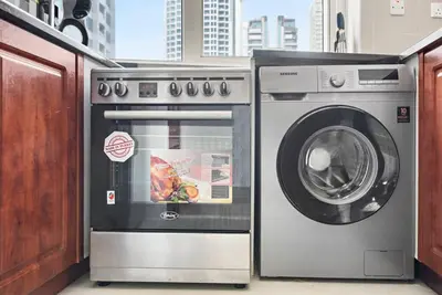 a washer and a washing machine in a room at StoneTree - Furnished 1BR with Modern Design in Dubai