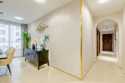 a hallway of a home with a table and a mirror at GlobalStay 3 Bedroom Apartment near JBR Beach Dubai Marina in Dubai