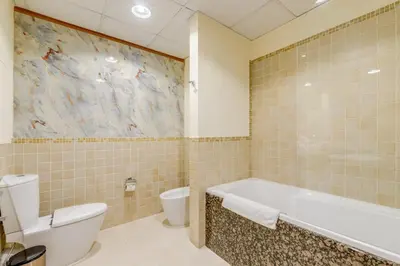a bathroom with a bath tub and a toilet at GlobalStay 3 Bedroom Apartment near JBR Beach Dubai Marina in Dubai