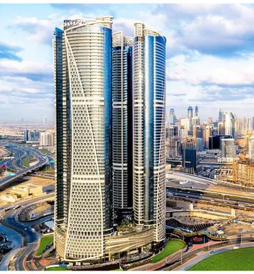 a group of tall skyscrapers in a city at ROYAL APARTMENTS By Damac Paramount Towers B Burj Khalifa Views in Dubai