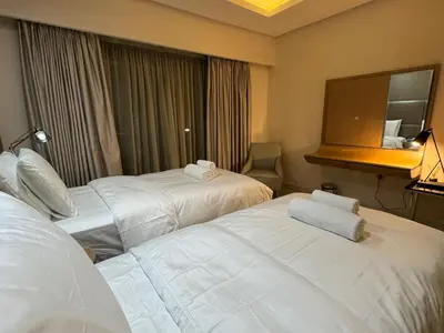 a hotel room with two beds and a mirror at ROYAL APARTMENTS By Damac Paramount Towers B Burj Khalifa Views in Dubai