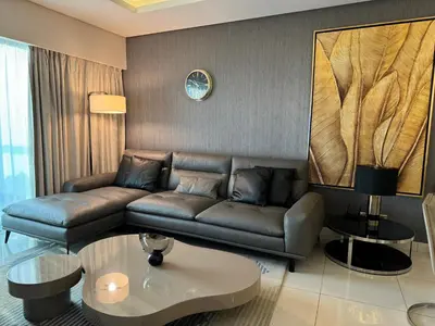 a living room with a couch and a table at ROYAL APARTMENTS By Damac Paramount Towers B Burj Khalifa Views in Dubai