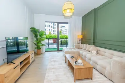a living room with a couch and a coffee table at Azure Escape !Joyful 1 Bed Apartment close to the Sea! in Dubai