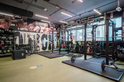 a gym with a bunch of equipment in it at StoneTree - Modern 1BR with Amazing Building Facilities in Dubai