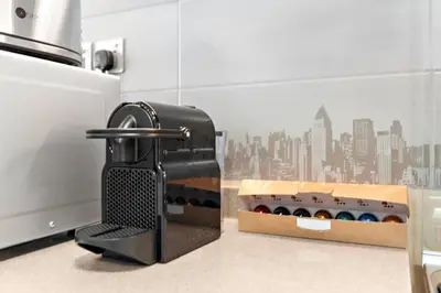 a black toaster sitting next to a box of food at StoneTree - Modern 1BR with Amazing Building Facilities in Dubai