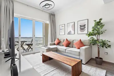 a living room with a couch and a table at StoneTree - Amazing 1BR with Lake View in Dubai