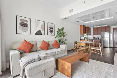 a living room with a couch and a table at StoneTree - Amazing 1BR with Lake View in Dubai