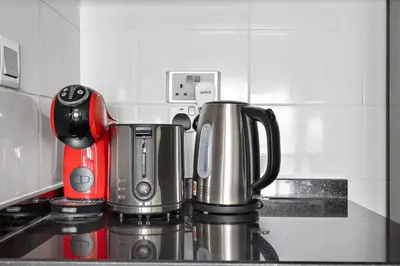 a coffeemaker sitting on top of a kitchen counter at StoneTree - Amazing 1BR with Lake View in Dubai