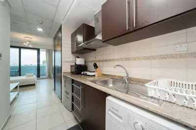 a kitchen with a sink and a counter top at StoneTree - Fully Furnished Studio with Spacious Balcony in Dubai