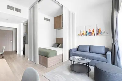 a living room with a blue couch and a bed at Exclusive Studio by Burj Khalifa and Dubai Mall, High Floor in Dubai