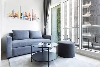 a living room with a couch and a table at Exclusive Studio by Burj Khalifa and Dubai Mall, High Floor in Dubai